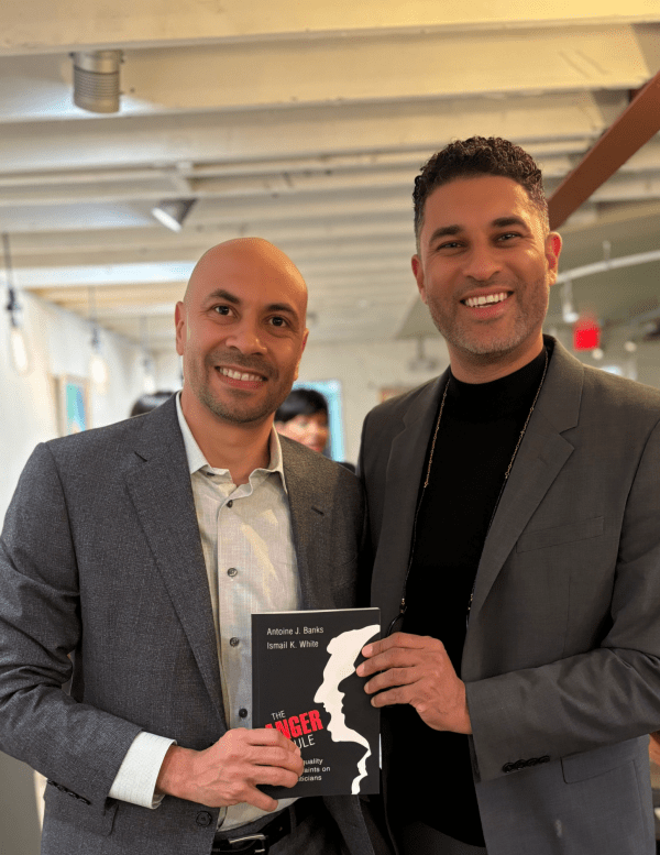 Antoine Banks and Ismail White holding their book: The Anger Rule